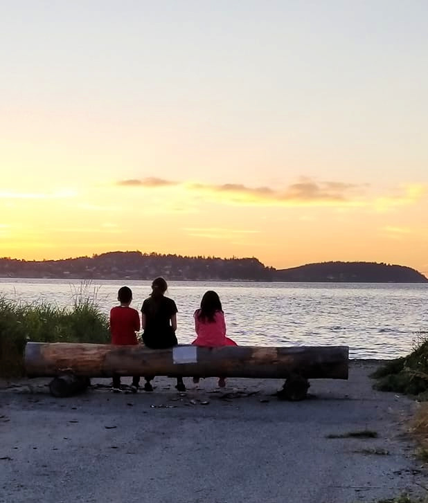 Kids On Log Watching Sunset At Fort Flagler